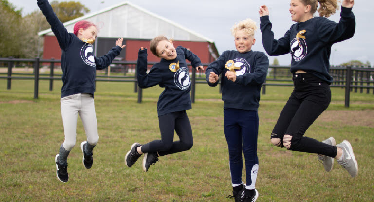 Barns från Agrias Ponnyklubb hoppar av glädje.